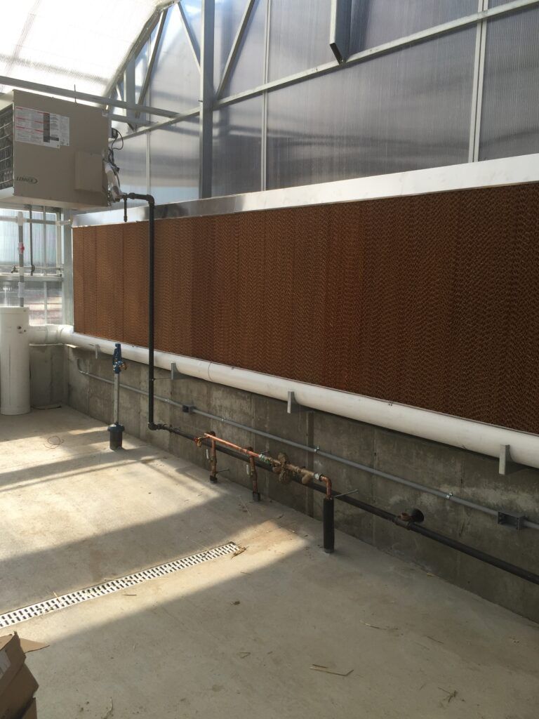 Evaporative pad system in educational greenhouse used for cooling.