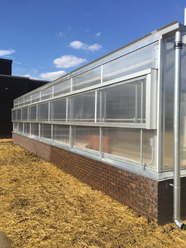 Side view of Vail greenhouse at Trail High School showing side vents used for ventilation. 