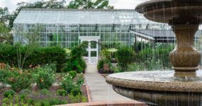 Conservatory glasshouse at Memphis Botanic Garden surrounded by outside gardens and outdoor classroom space