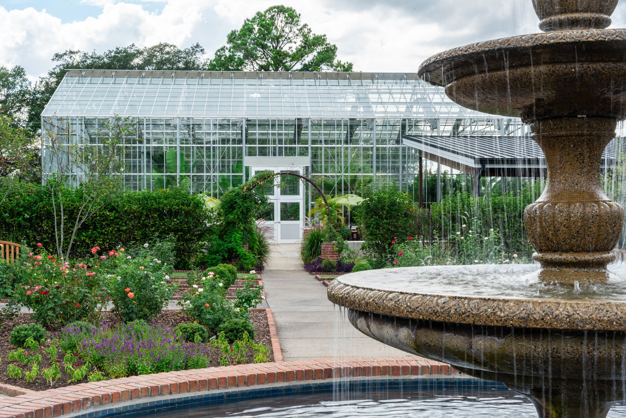 Conservatory glasshouse at Memphis Botanic Garden surrounded by outside gardens and outdoor classroom space